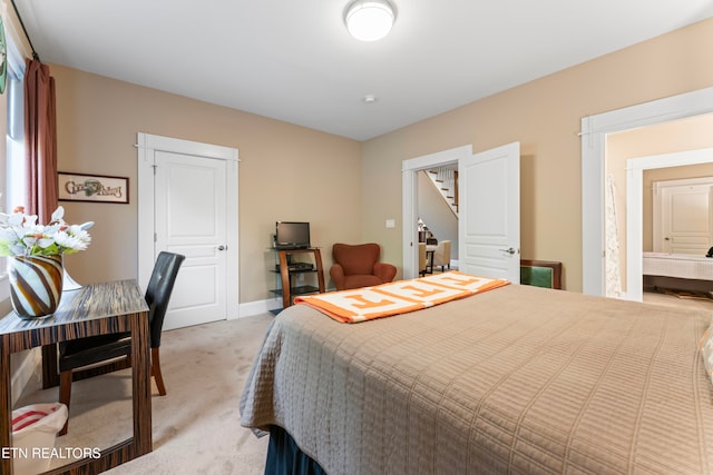 bedroom featuring light carpet