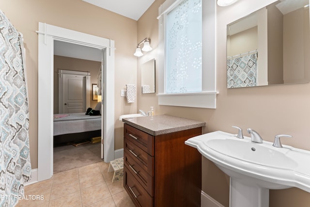 bathroom with tile patterned flooring and dual sinks