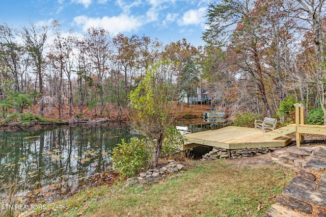 view of yard featuring a deck with water view