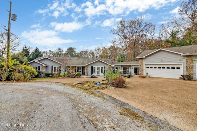 ranch-style home with a porch and a garage