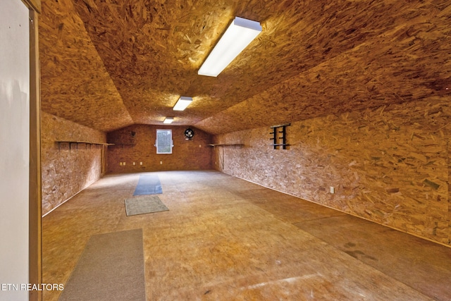 additional living space featuring lofted ceiling