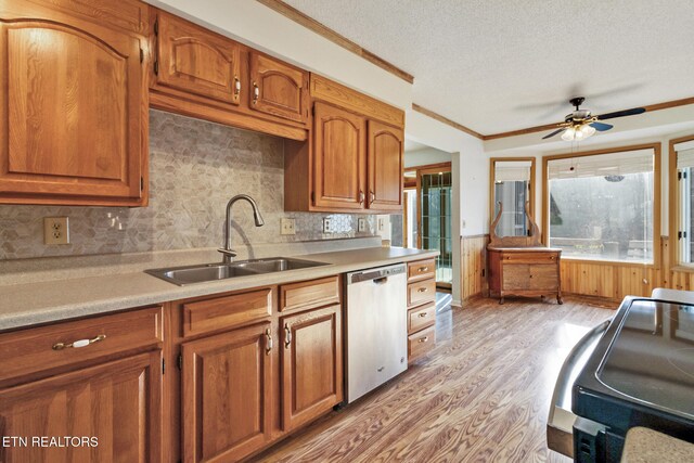 kitchen with dishwasher, sink, ceiling fan, a textured ceiling, and light hardwood / wood-style floors