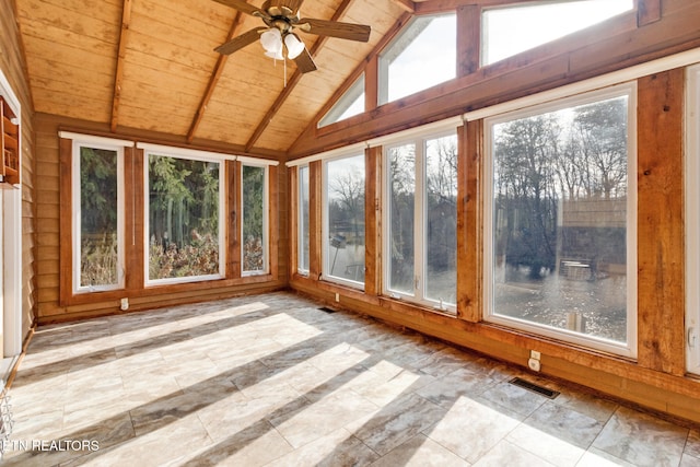 unfurnished sunroom with lofted ceiling with beams, ceiling fan, wood ceiling, and a wealth of natural light