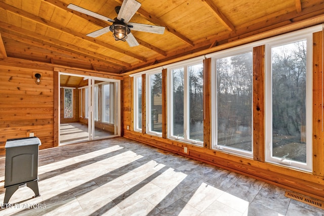 unfurnished sunroom featuring lofted ceiling with beams, wood ceiling, a wealth of natural light, and ceiling fan