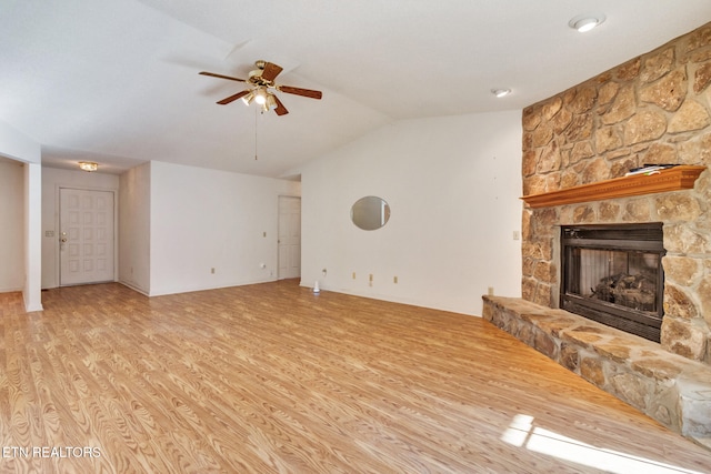 unfurnished living room with ceiling fan, a stone fireplace, light wood-type flooring, and lofted ceiling