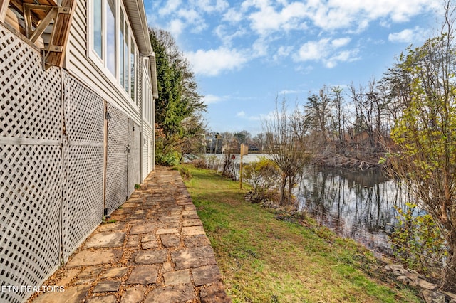 exterior space with a lawn and a water view