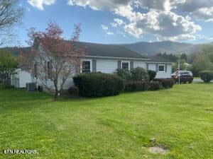 exterior space with a mountain view and a yard