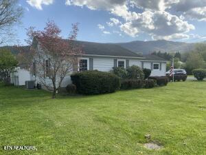 1315 Winchester Ave, Middlesboro, KY 40965 - rear view of property with a yard and a mountain view