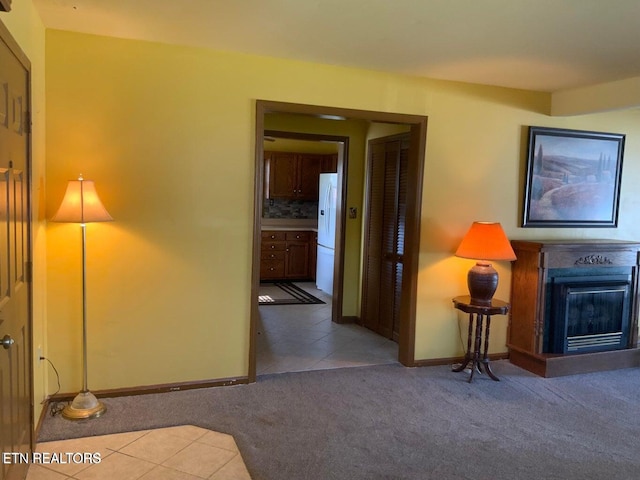 hallway featuring light colored carpet