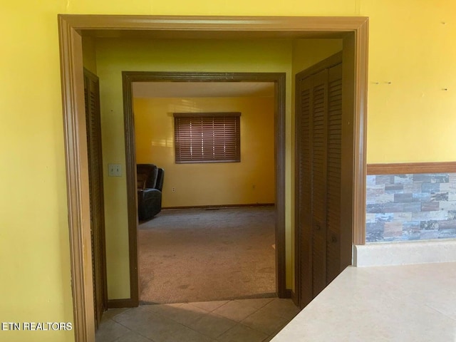 hallway featuring light carpet