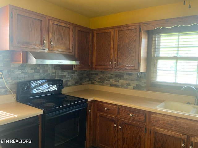 1315 Winchester Ave, Middlesboro, KY 40965 - kitchen featuring black range with electric cooktop, wall chimney range hood, light countertops, and a sink