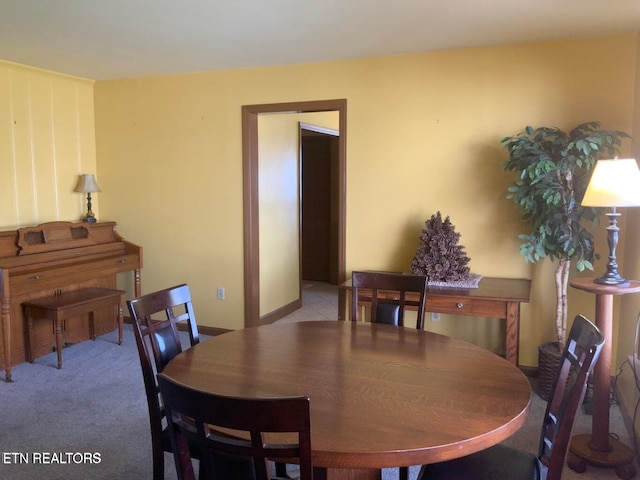 dining space with light colored carpet