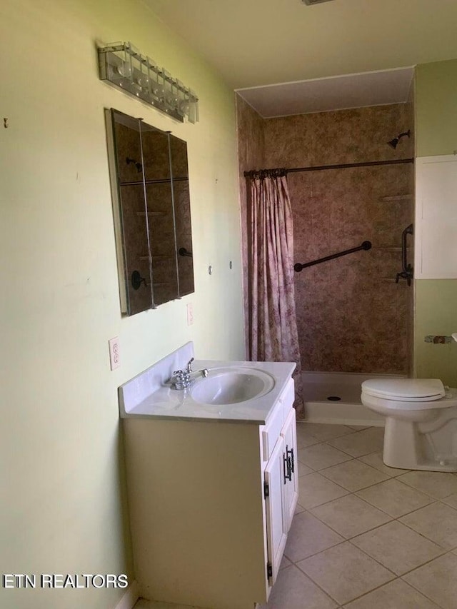 bathroom with walk in shower, vanity, toilet, and tile patterned floors