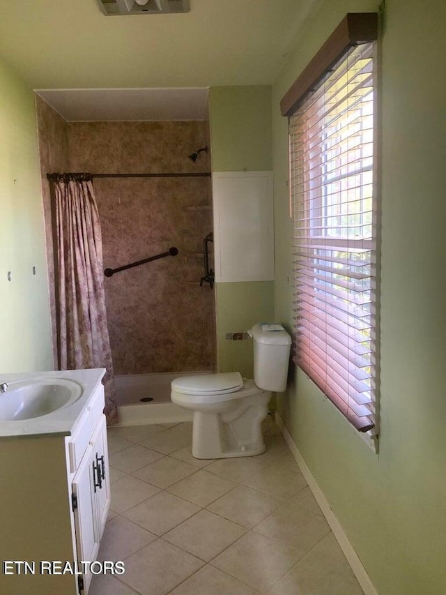 bathroom with toilet, vanity, tile patterned floors, and a shower with curtain