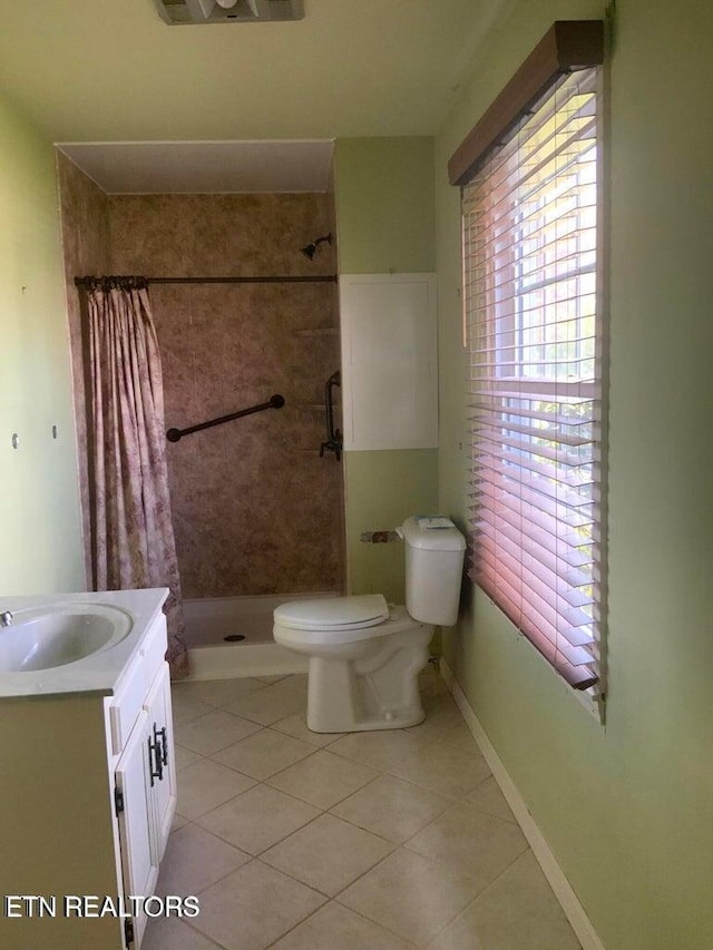 1315 Winchester Ave, Middlesboro, KY 40965 - bathroom with toilet, a stall shower, tile patterned floors, and vanity