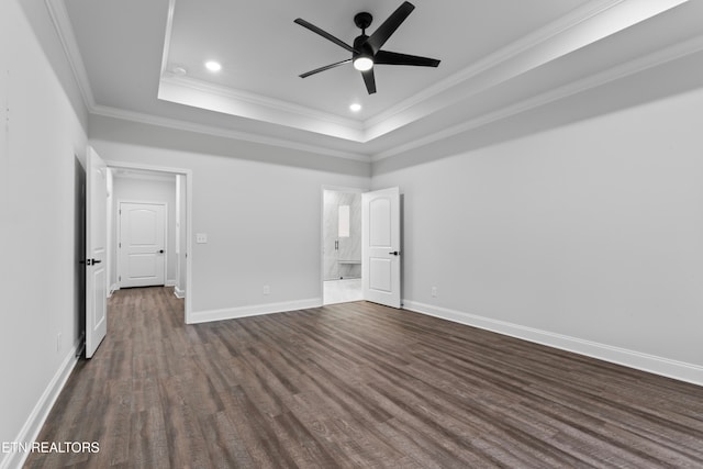 unfurnished bedroom featuring dark wood-type flooring, ceiling fan, a raised ceiling, and ornamental molding