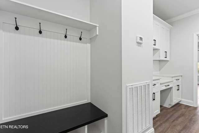 mudroom featuring dark wood-type flooring and ornamental molding