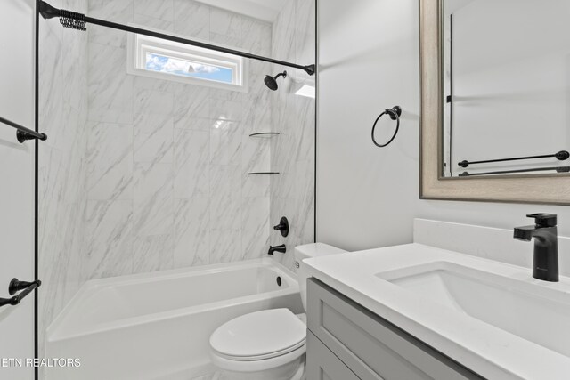 full bathroom with vanity, toilet, and tiled shower / bath combo