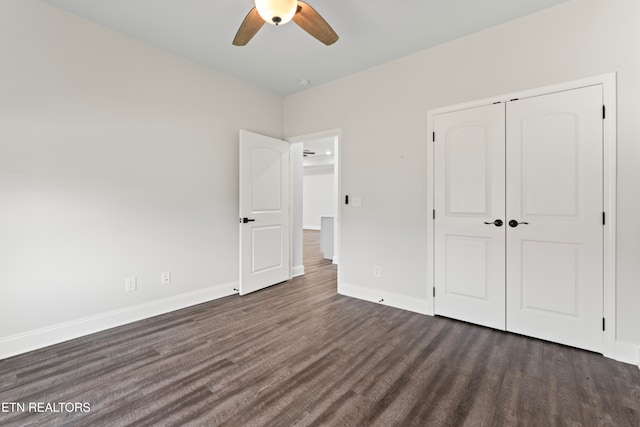 unfurnished bedroom with ceiling fan, a closet, and dark hardwood / wood-style flooring