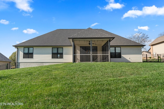 back of house with a lawn and a sunroom