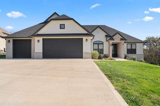 view of front of home featuring a front yard and a garage