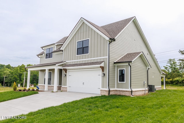 view of front of property with central AC unit, a garage, and a front yard