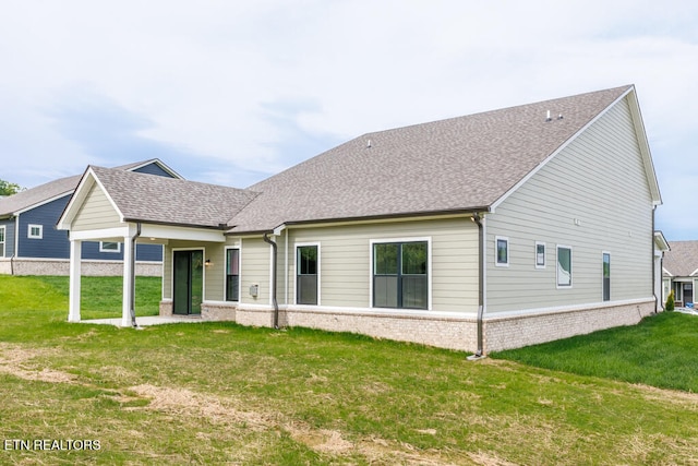 rear view of property featuring a yard