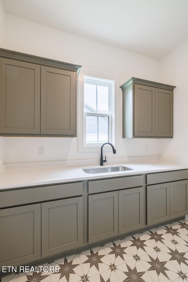 kitchen featuring gray cabinetry and sink