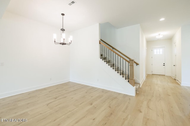 entrance foyer featuring light hardwood / wood-style floors and an inviting chandelier