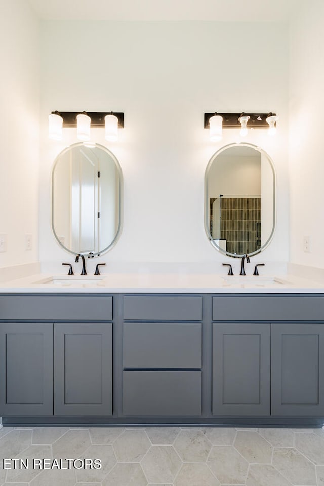 bathroom with tile patterned flooring and vanity