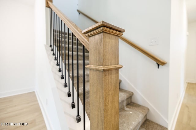 stairway with hardwood / wood-style floors