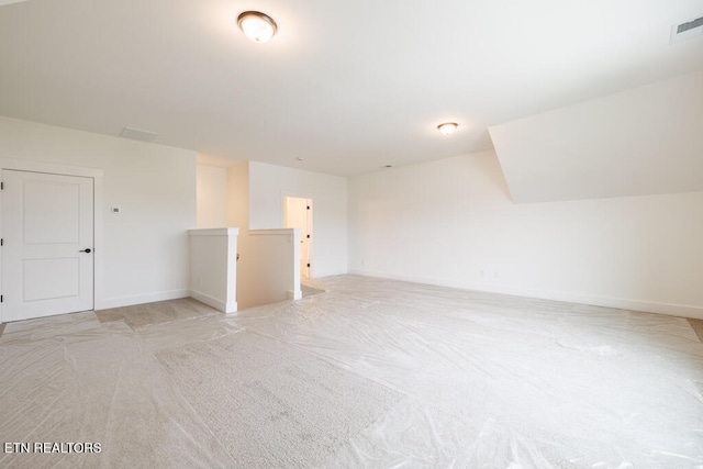 unfurnished room featuring light colored carpet