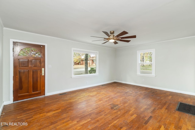 entryway featuring ceiling fan, wood-type flooring, plenty of natural light, and crown molding