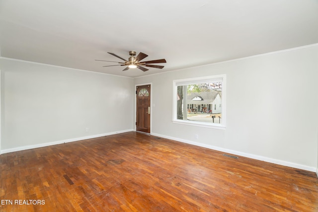 empty room featuring hardwood / wood-style flooring, ceiling fan, and ornamental molding