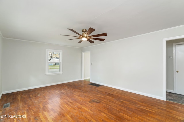 spare room featuring dark wood-type flooring, ceiling fan, and ornamental molding