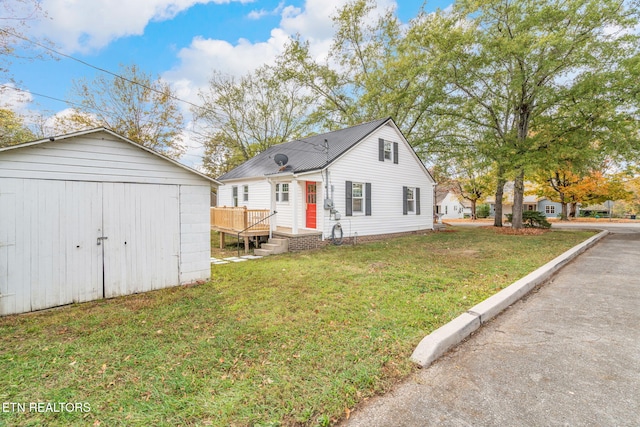 view of front of house with a front lawn, a storage unit, and a wooden deck