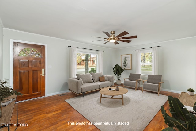 living room with hardwood / wood-style floors, ceiling fan, and crown molding