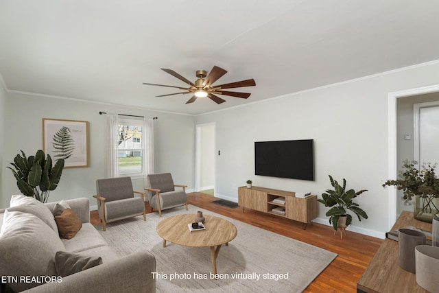 living room with wood-type flooring, ceiling fan, and crown molding