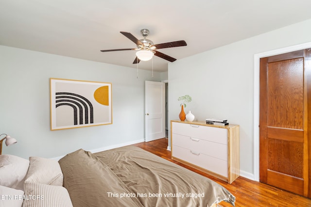 bedroom with light hardwood / wood-style floors and ceiling fan