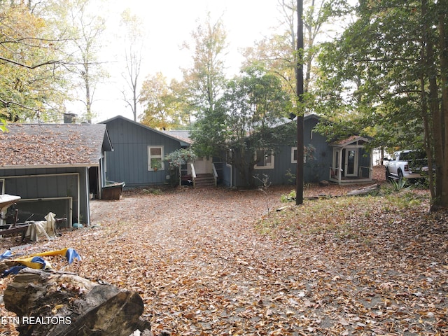 back of property featuring a garage