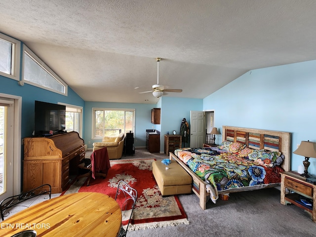 bedroom featuring carpet flooring, a textured ceiling, ceiling fan, and vaulted ceiling