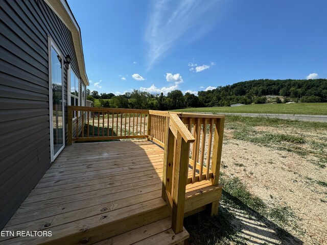 wooden terrace with a rural view