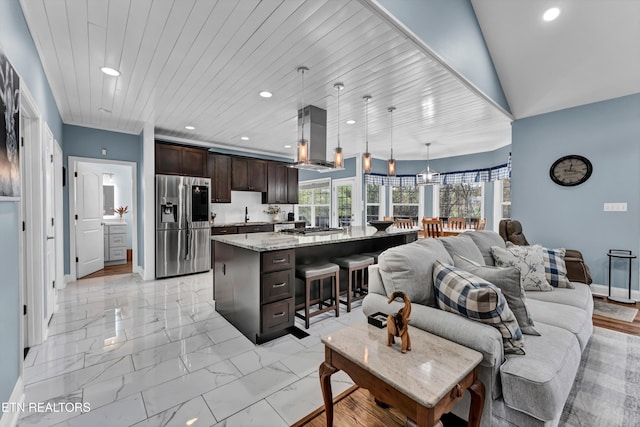 living room with sink, wooden ceiling, and lofted ceiling