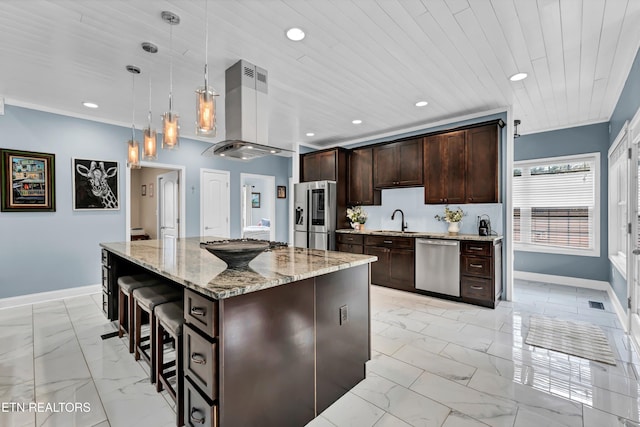 kitchen featuring a center island, sink, stainless steel appliances, pendant lighting, and dark brown cabinets