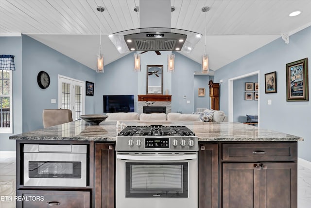 kitchen featuring high end stove, dark brown cabinetry, light stone countertops, and hanging light fixtures