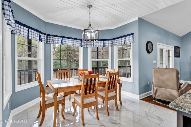 dining room featuring a healthy amount of sunlight, wooden ceiling, and an inviting chandelier