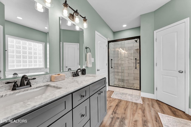 bathroom with vanity, hardwood / wood-style flooring, and walk in shower