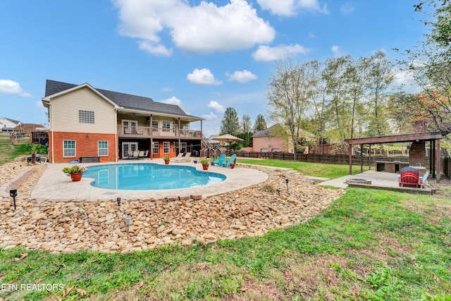 view of swimming pool with a patio area, a yard, and a wooden deck