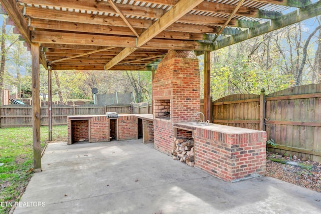 view of patio with an outdoor brick fireplace and a pergola