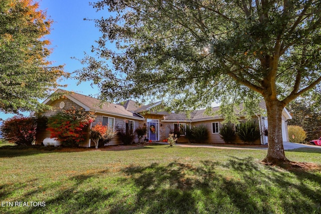 ranch-style home with a front yard and a garage